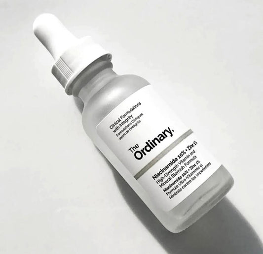 Skincare serum bottle labeled 'The Ordinary' on a light gray background